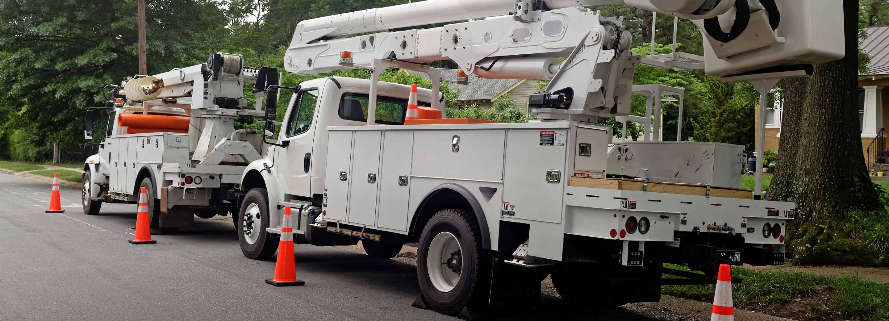 white boom truck with traffic cones