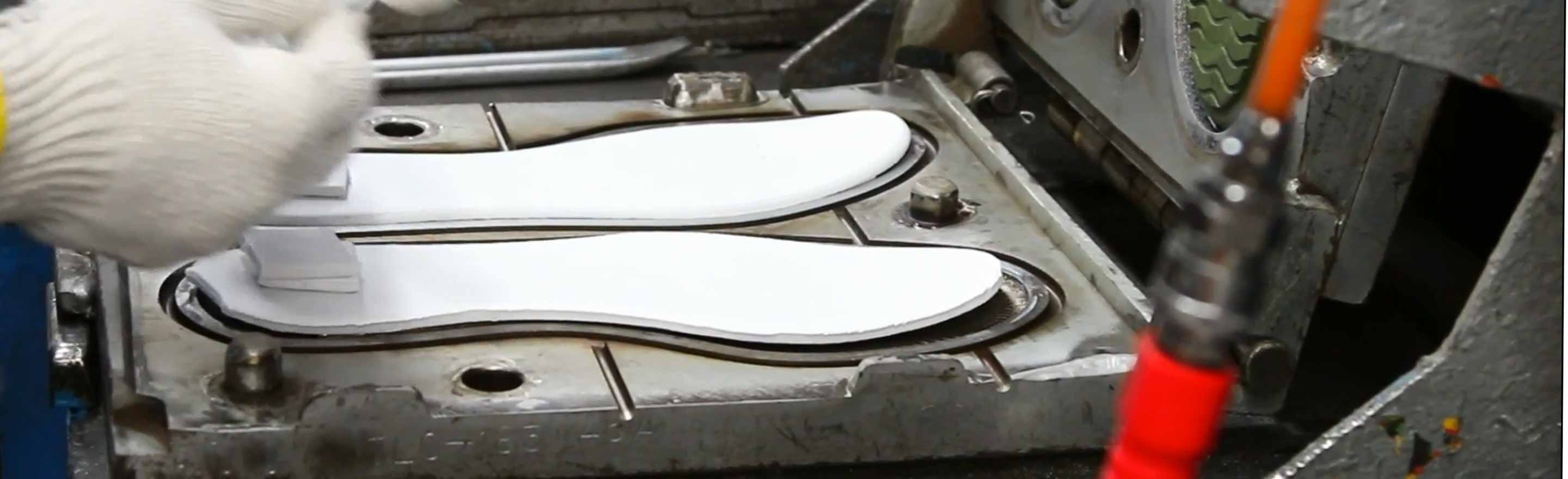 Shoe insoles in mold machine being removed with LORD LokRelease mold Release.