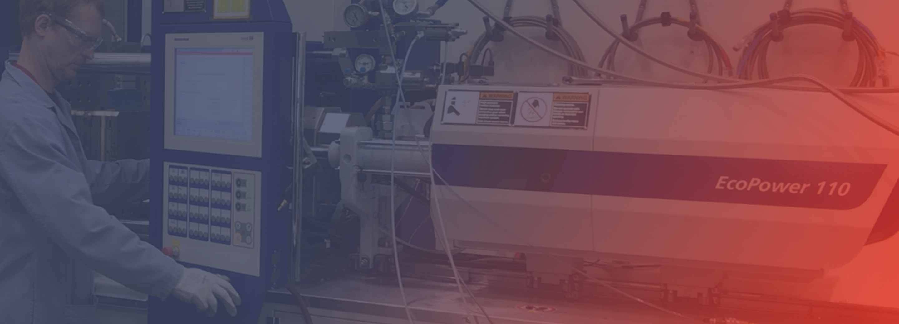 man working on injection molding machine