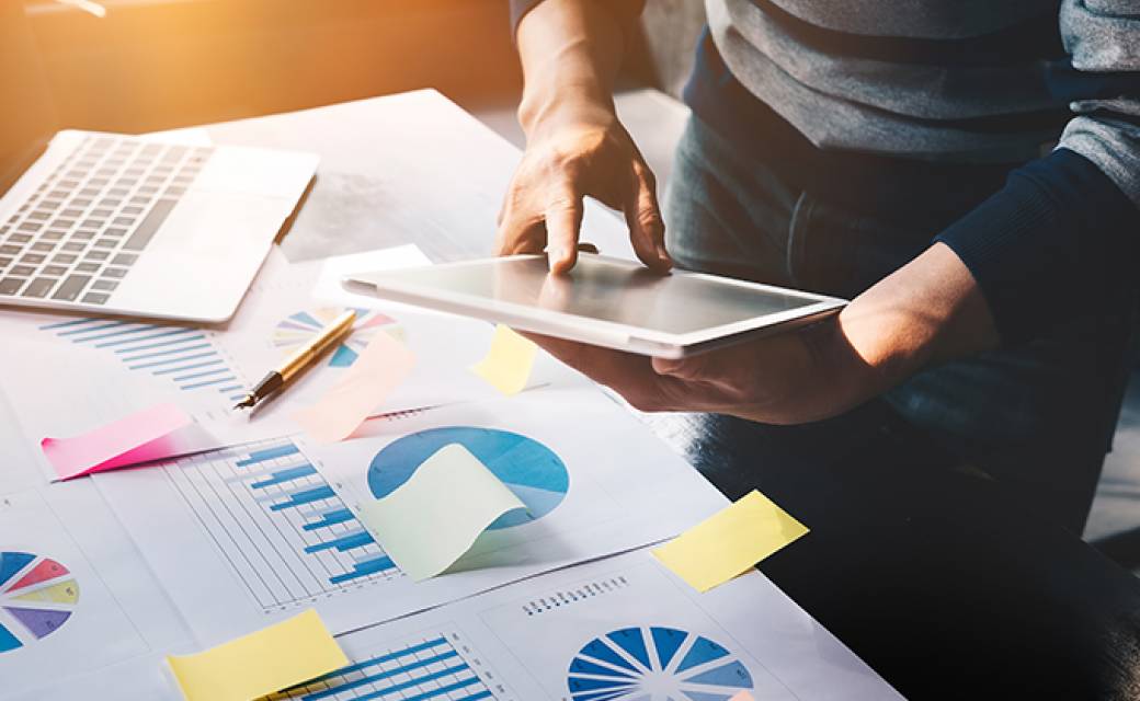 person looking at cost savings on paper