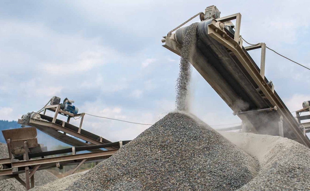 Mining operation with rubber conveyor belt dropping dirt or rocks and can be repaired with Chemlok Cold-Bond Adhesives.